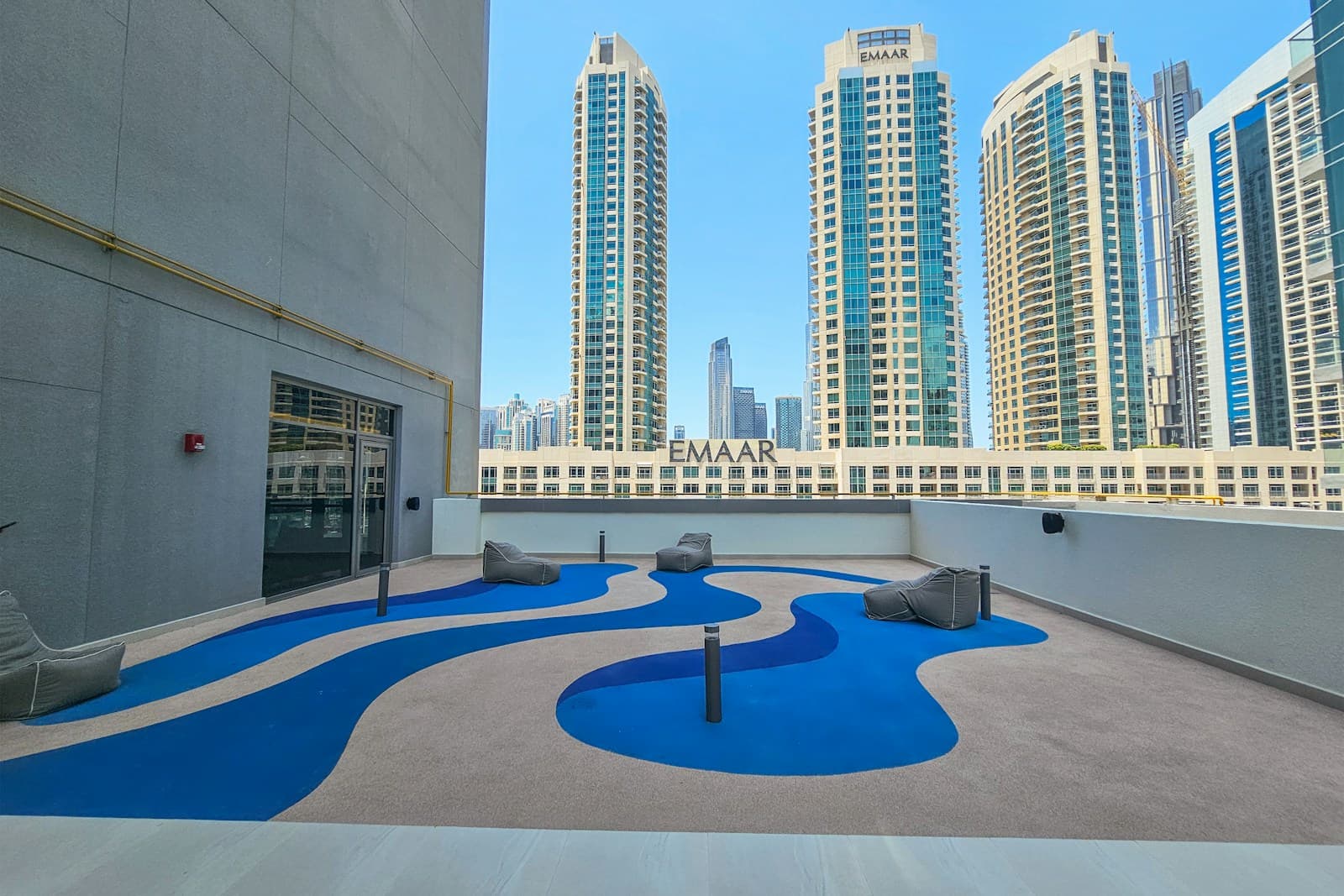Rooftop view across the Business Bay cluster showing the dense mixed-use tower landscape
