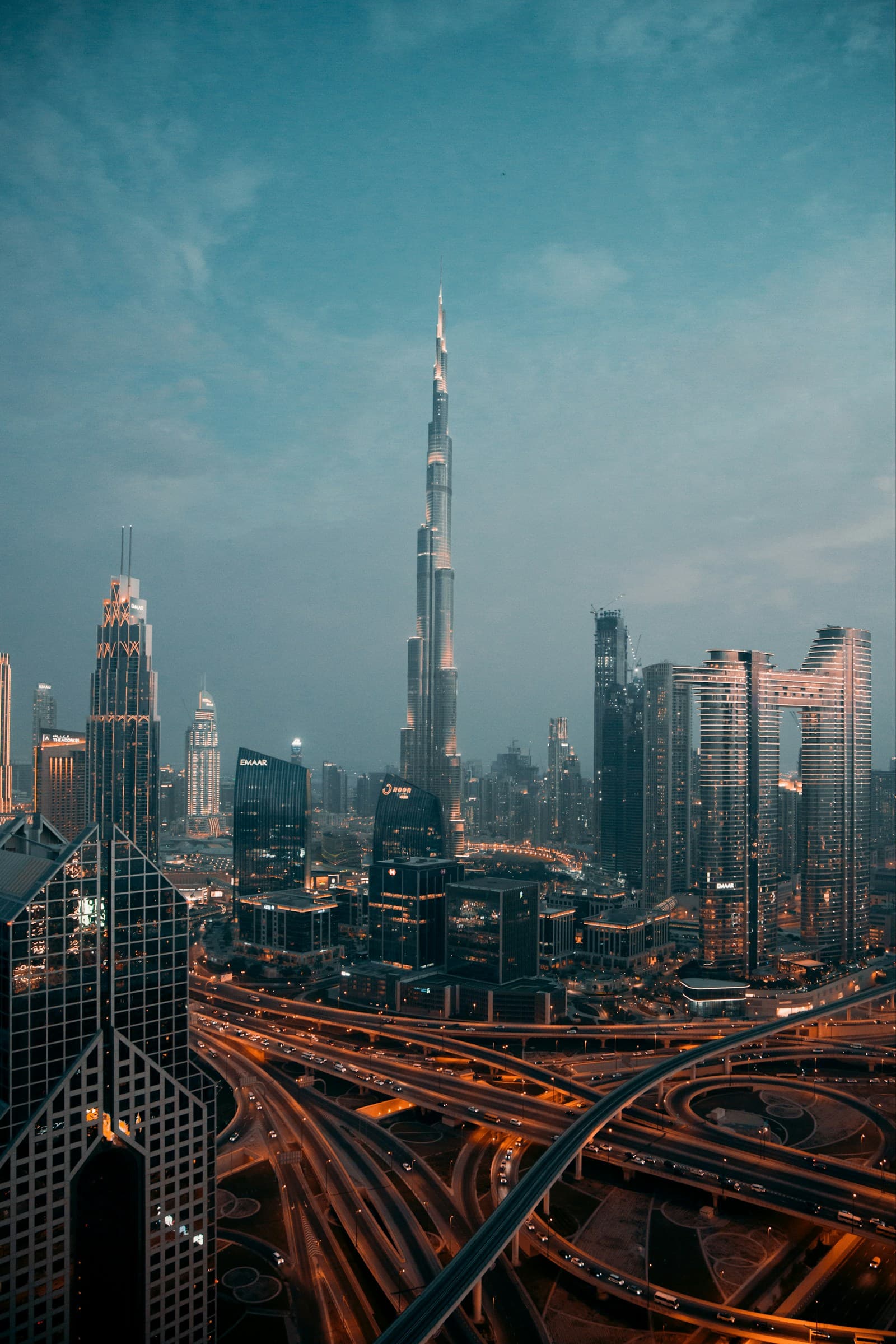 Downtown Dubai skyline at night seen from a high vantage point β Burj Khalifa and surrounding towers illuminated against the dark sky