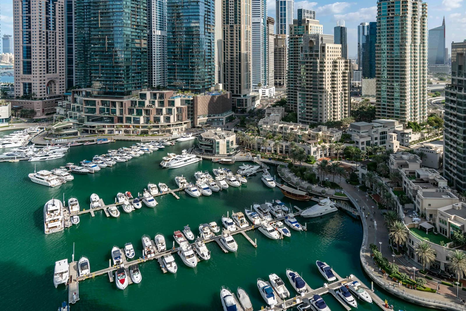 Dubai Marina canal lined with boats and high-rise residential towers